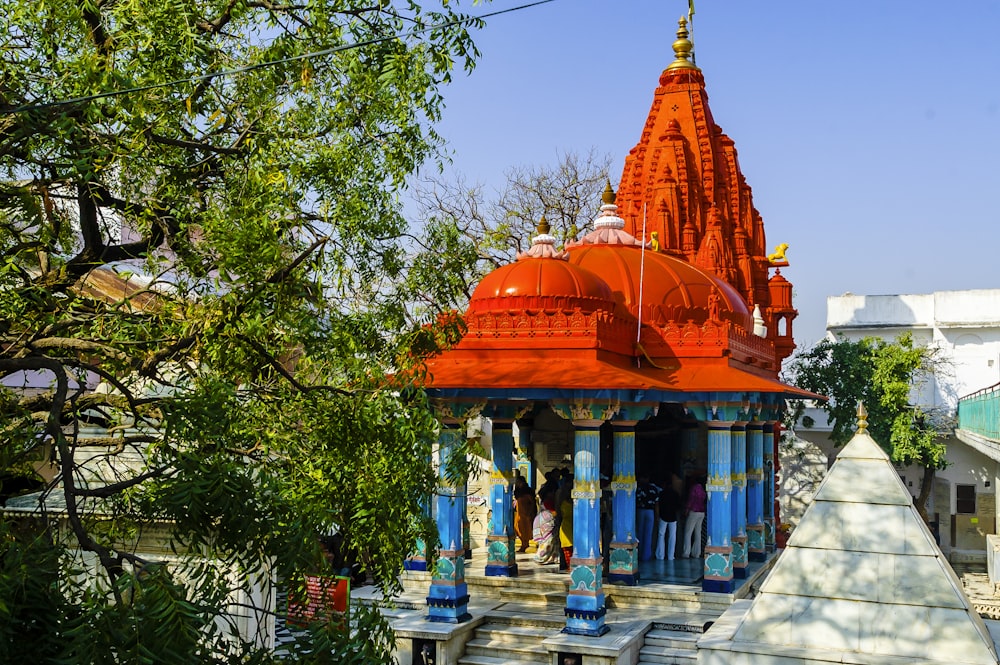 a colorfully painted temple in the middle of a park