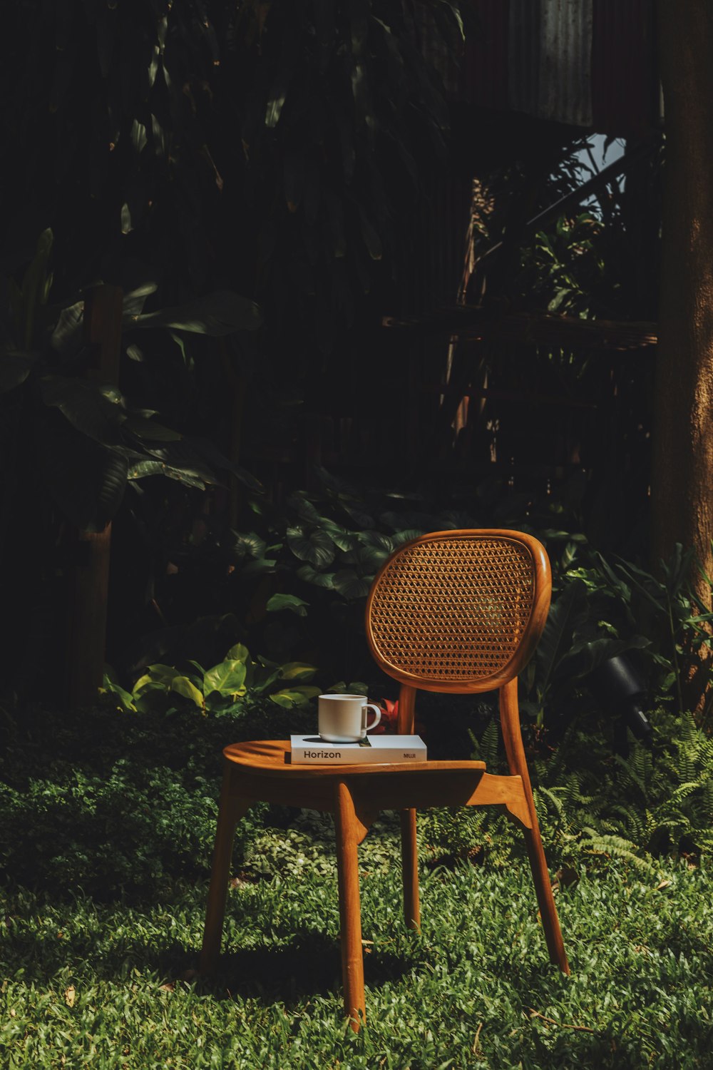 a wooden chair with a cup of coffee on top of it