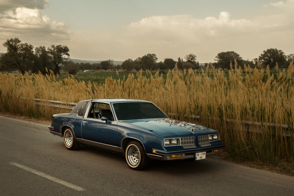 a blue car parked on the side of the road