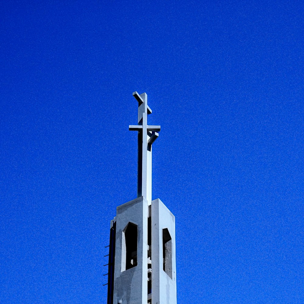 a tall white church steeple with a cross on top