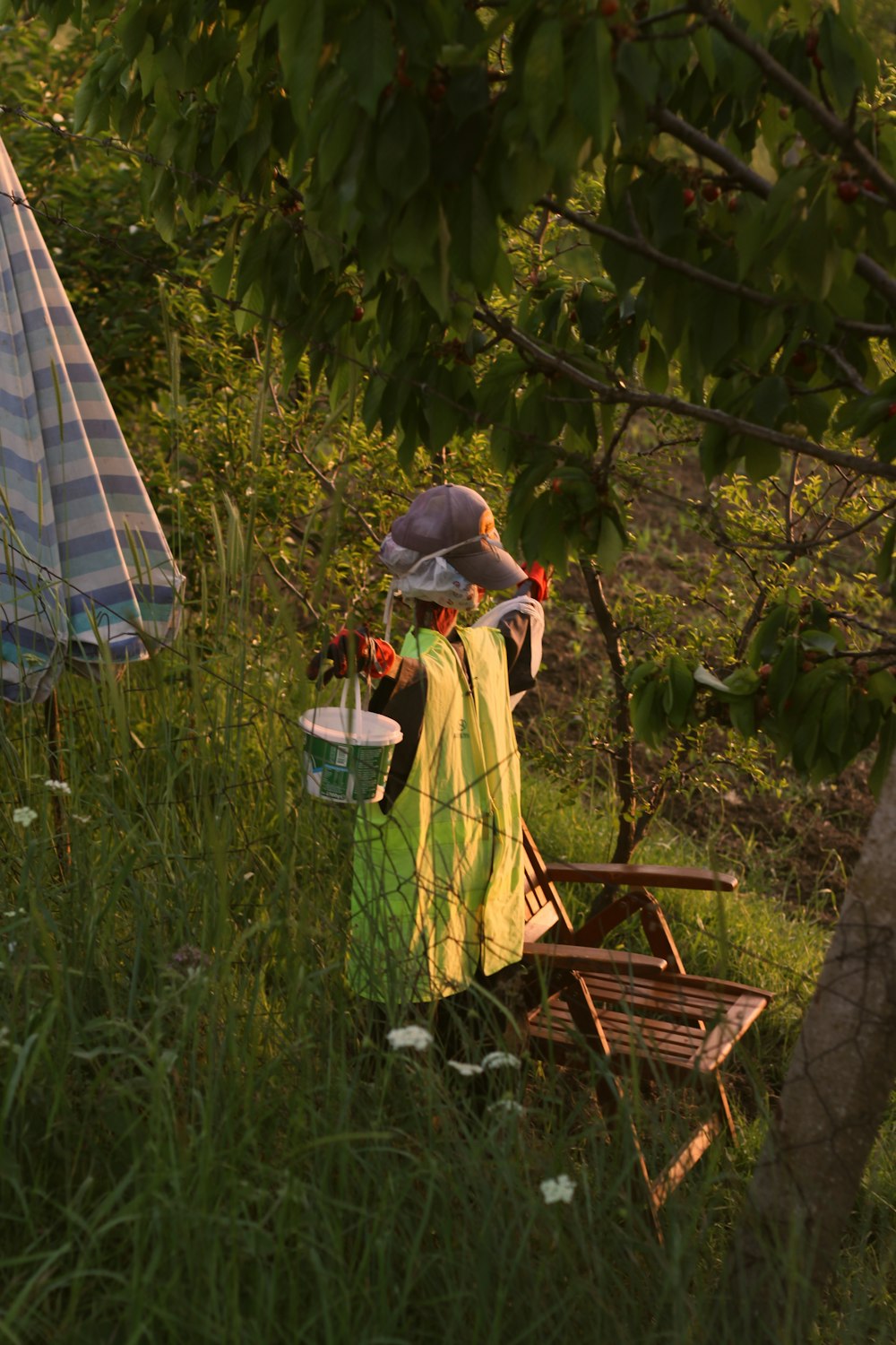 a woman sitting on a bench in a field