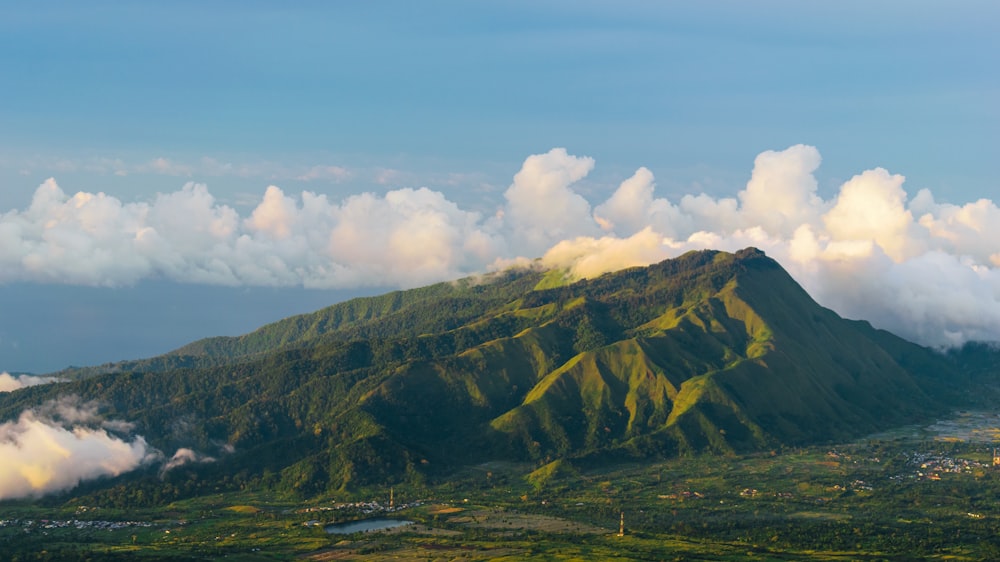 a view of a mountain with clouds in the sky