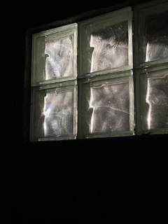Close-up of a brutalist-modern style glass block light fixture with soft illumination.