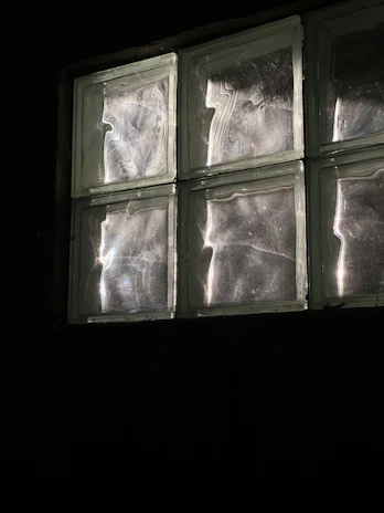 Close-up of a brutalist-modern style glass block light fixture with soft illumination.