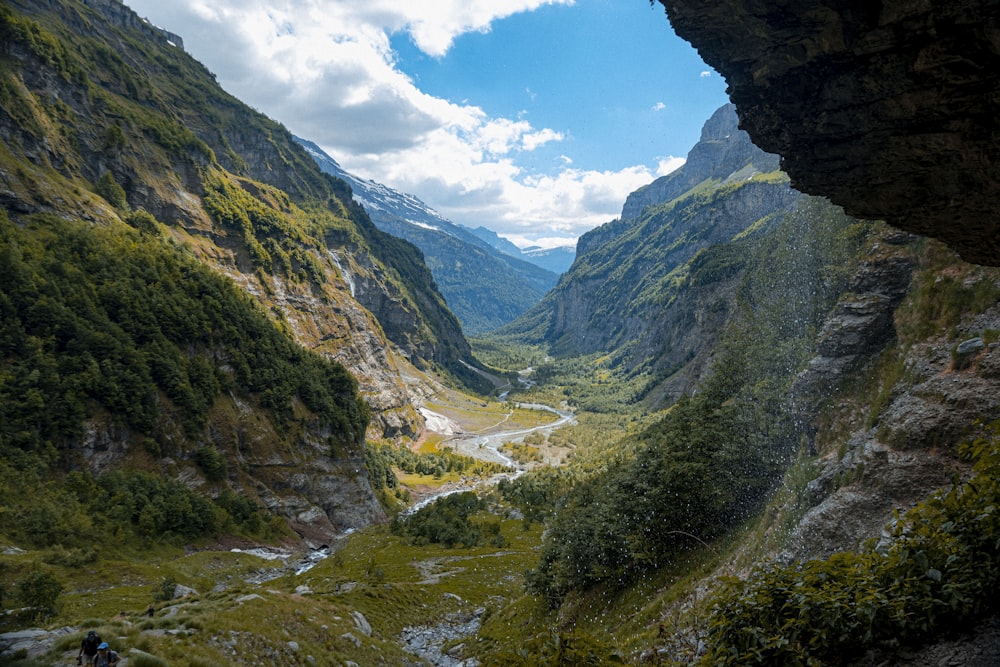 a view of a valley from inside a cave