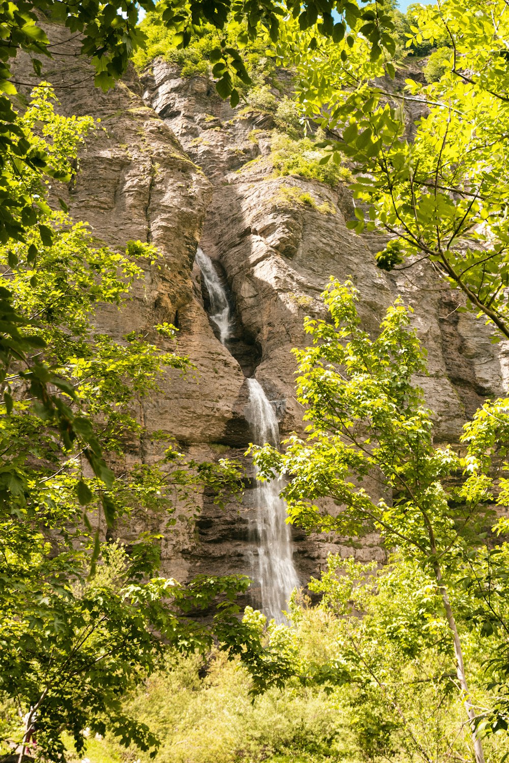 a waterfall is coming out of the side of a mountain