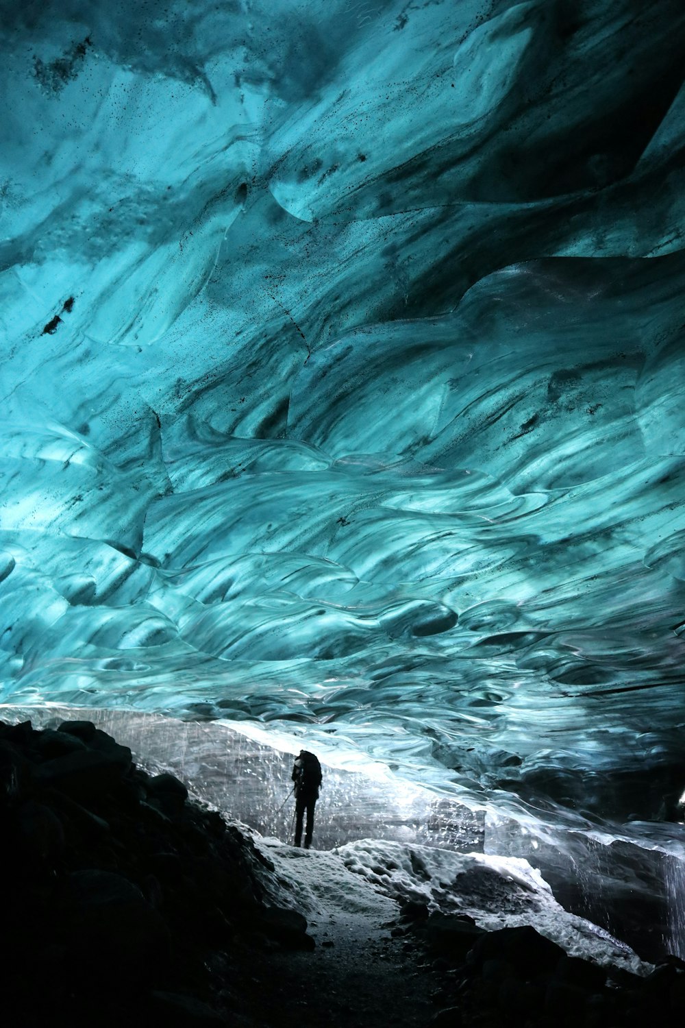 a person standing in a cave with a sky background