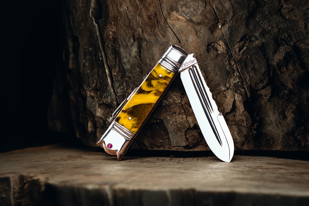 a couple of knives sitting on top of a wooden table