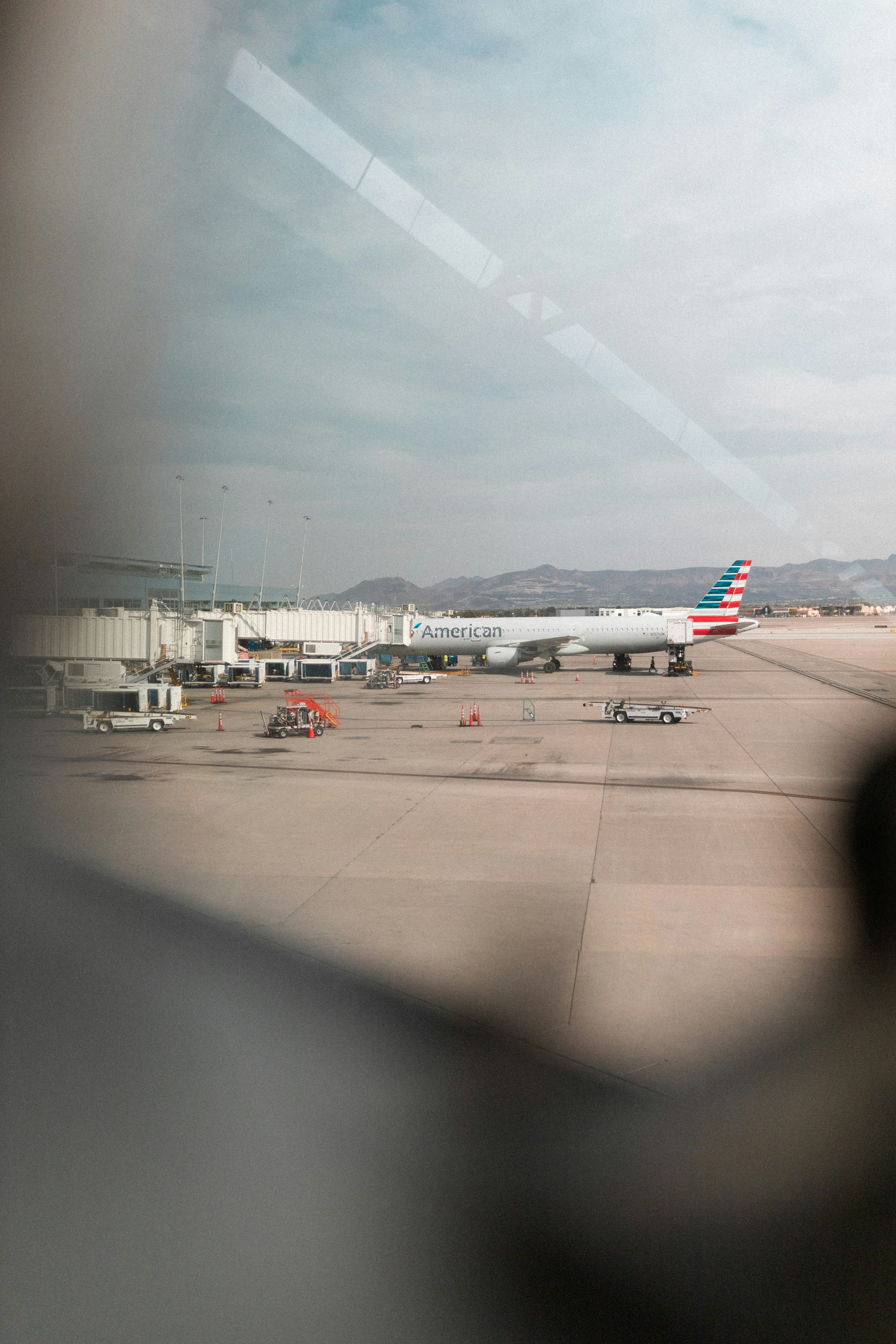 Airplane at airport gate with jet bridge attached