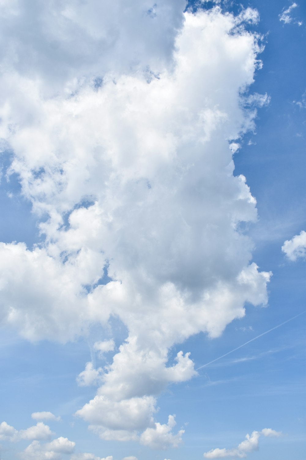 a person flying a kite in a blue sky