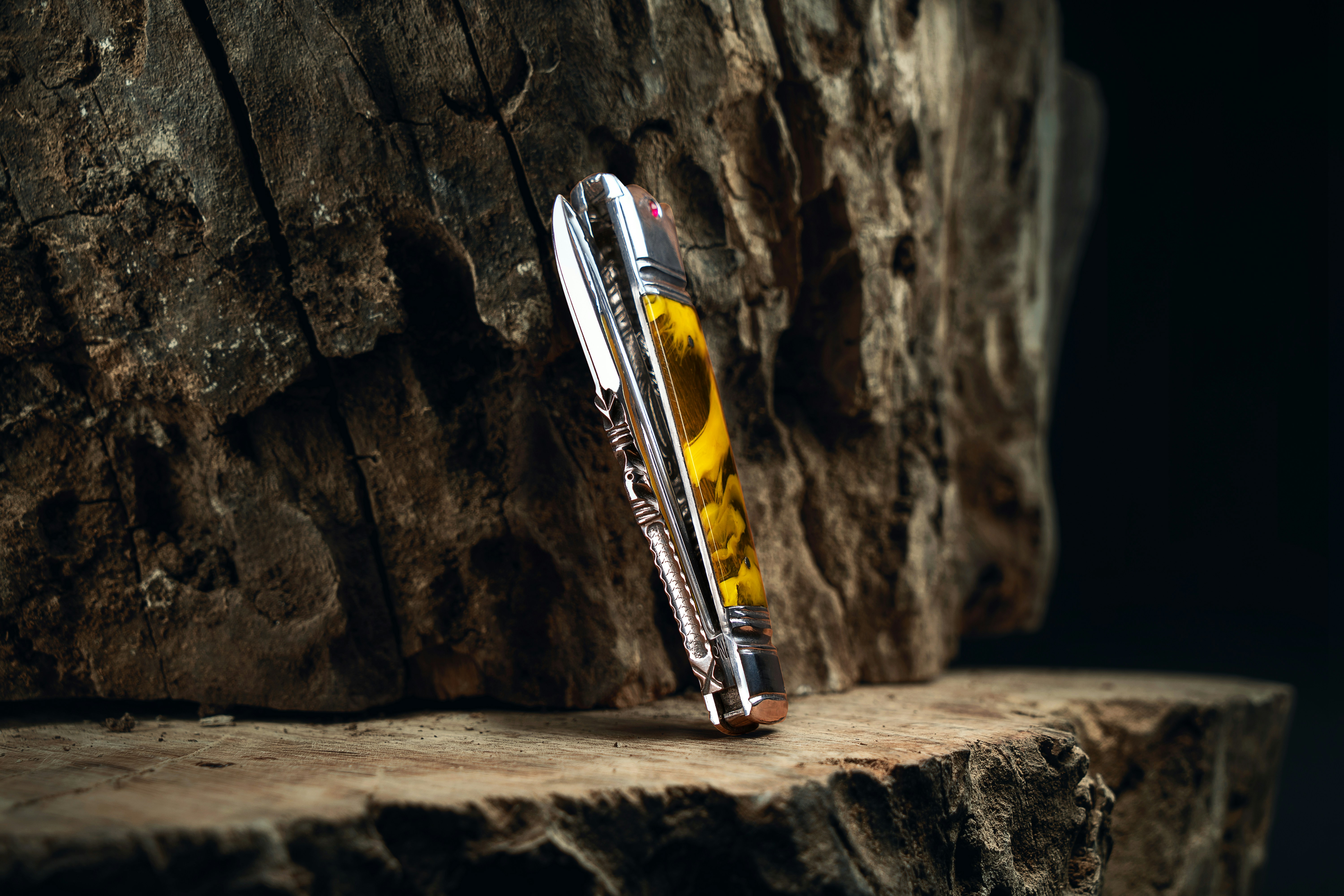 a pen sitting on top of a piece of wood