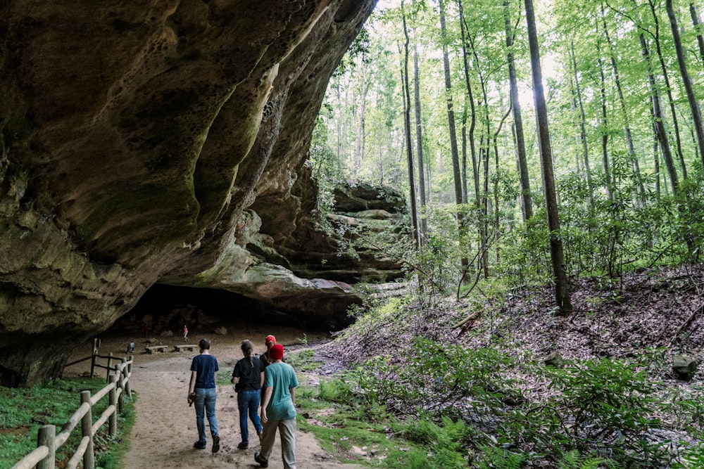 a group of people walking down a dirt road