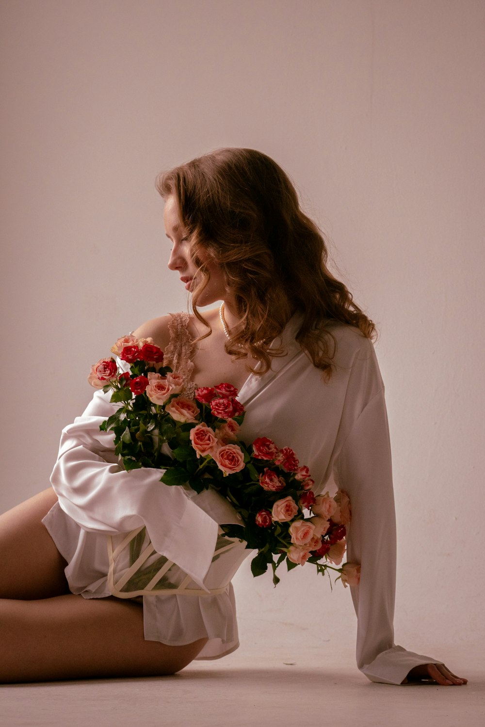 a woman in a white dress holding a bouquet of flowers