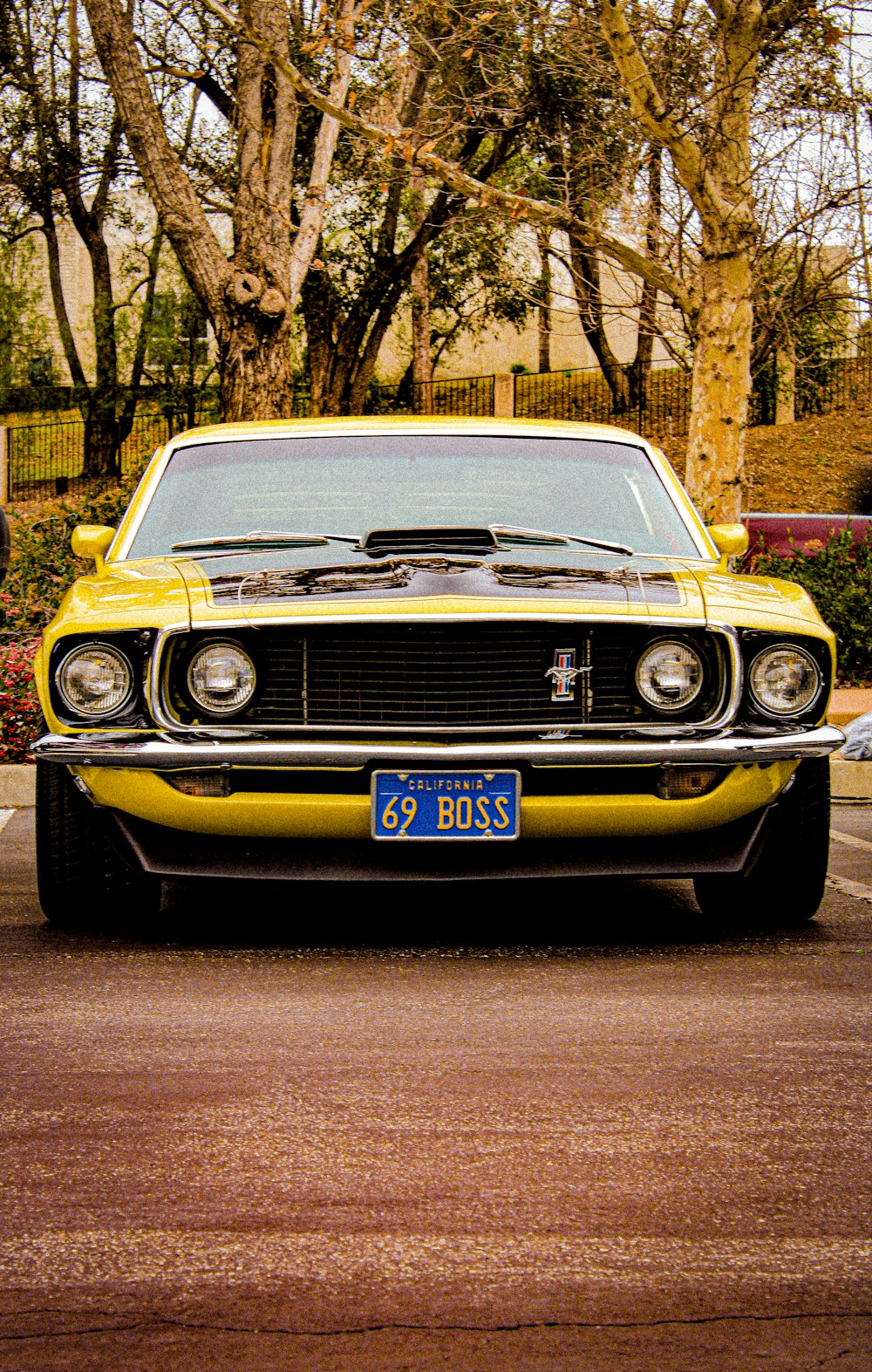 a yellow muscle car parked in a parking lot