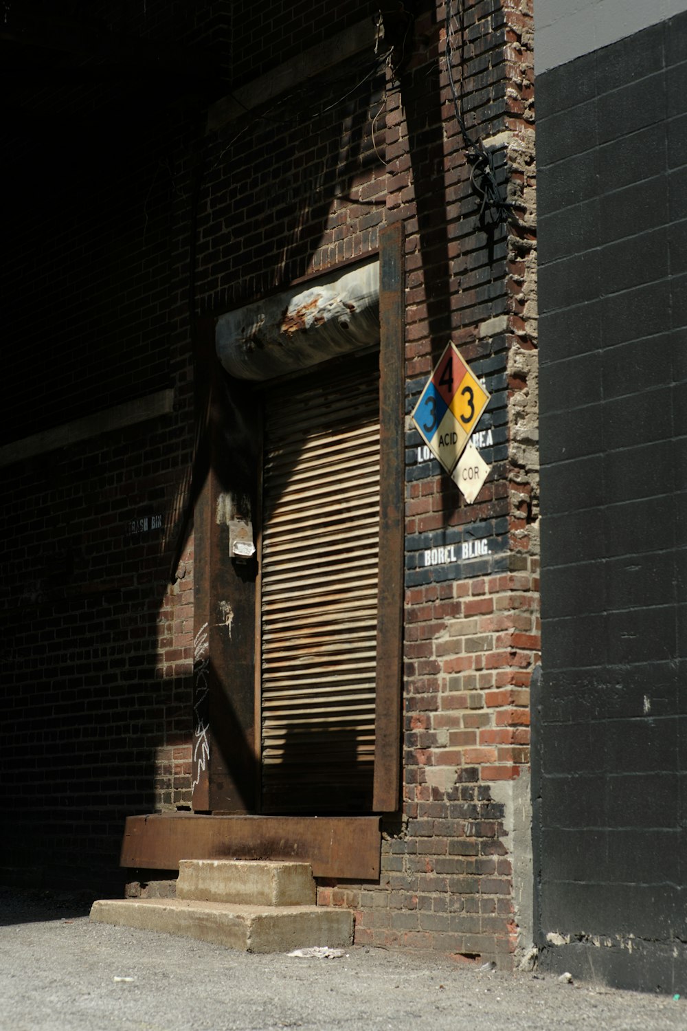 a brick building with a door and a sign on it