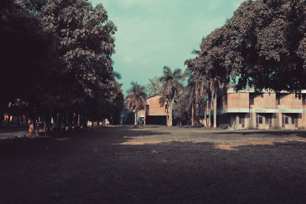 an old building surrounded by trees on a sunny day