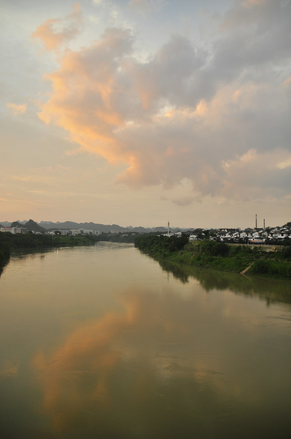 a body of water with a sky in the background