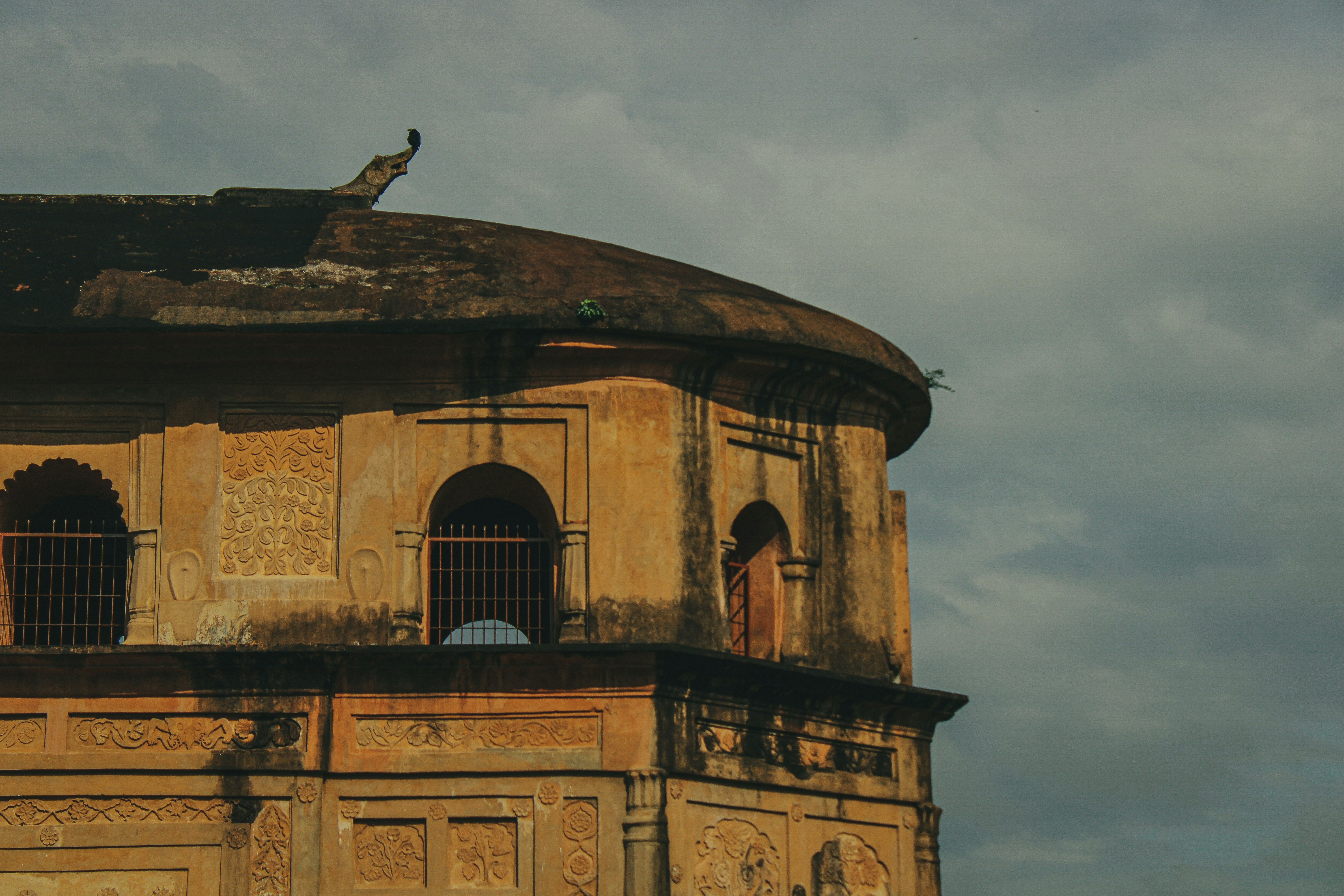 an old building with a bird perched on top of it