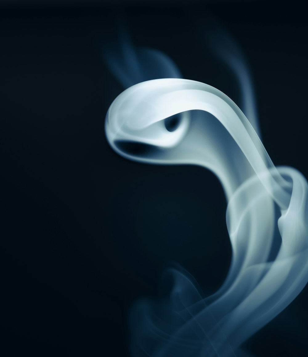 a white smoke swirl on a black background