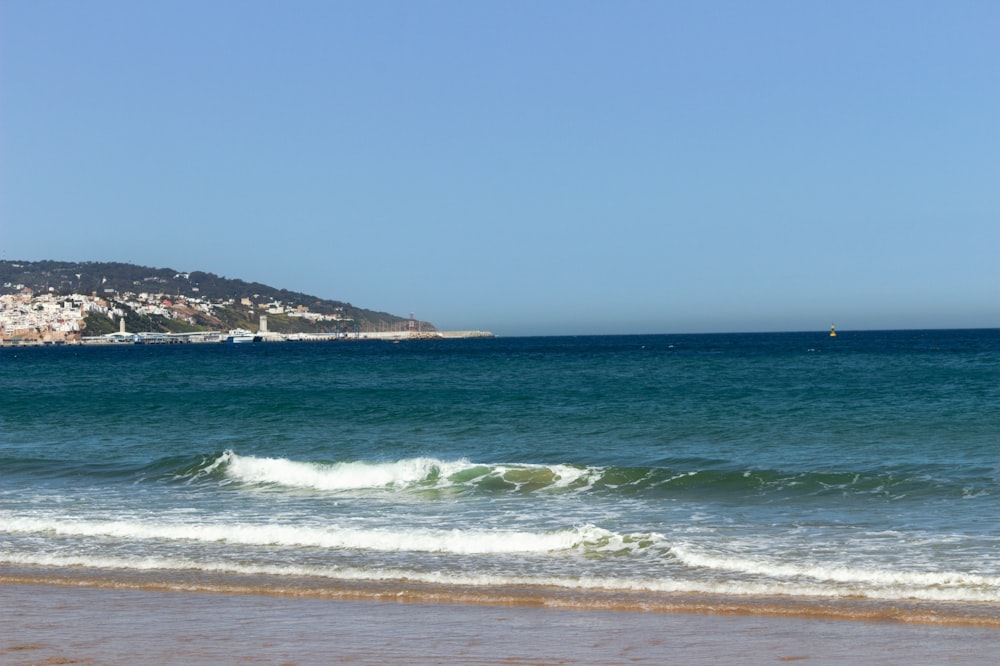 a view of the ocean with a city in the distance