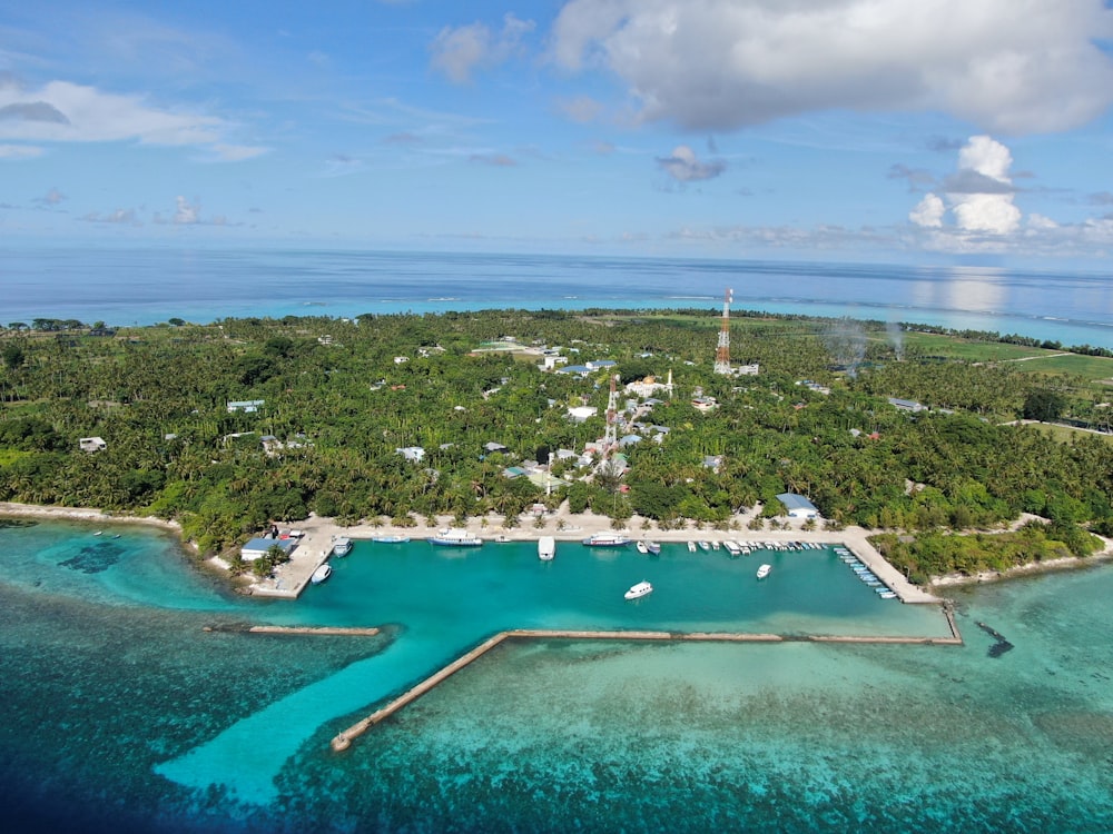 an aerial view of a tropical island with a lighthouse in the distance