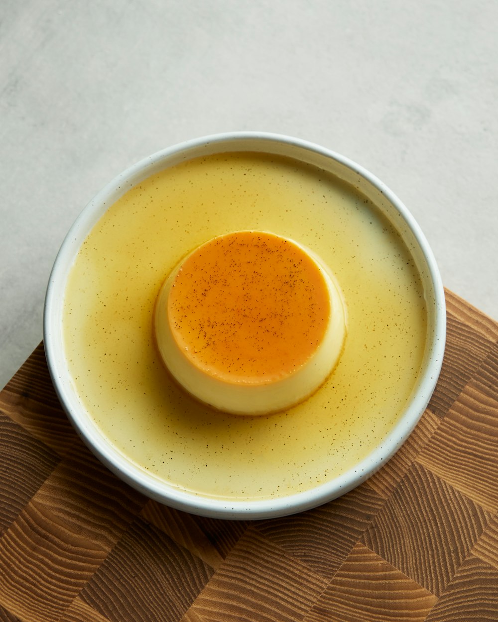 a bowl of soup sitting next to a cup of coffee