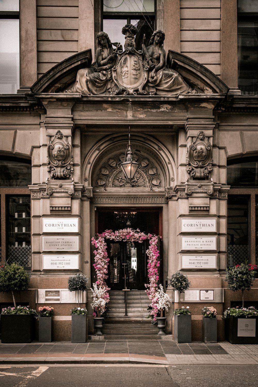 a large building with a bunch of flowers in front of it