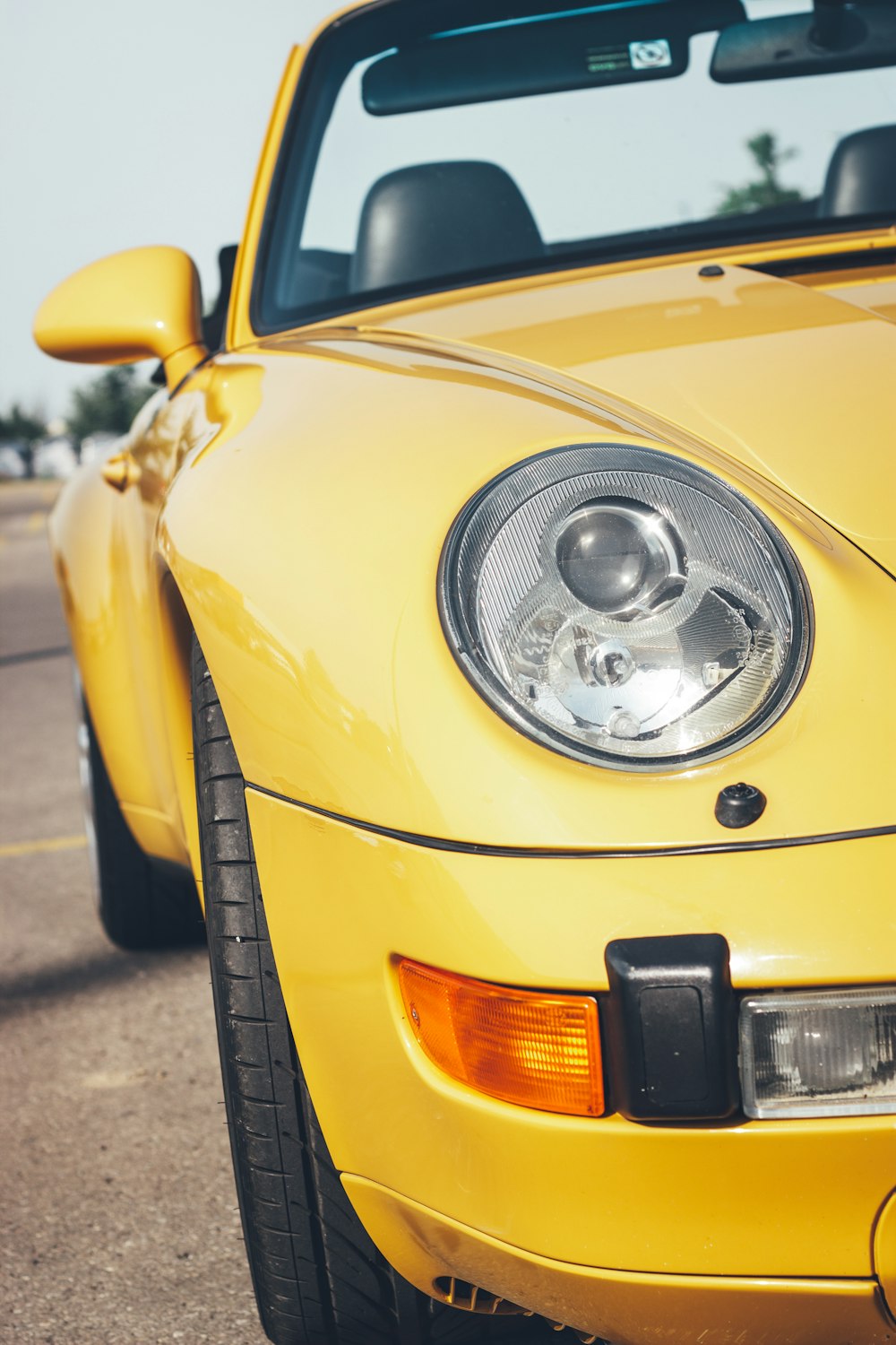 a yellow sports car parked in a parking lot