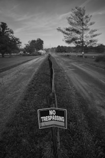 a no trespassing sign on the side of a road