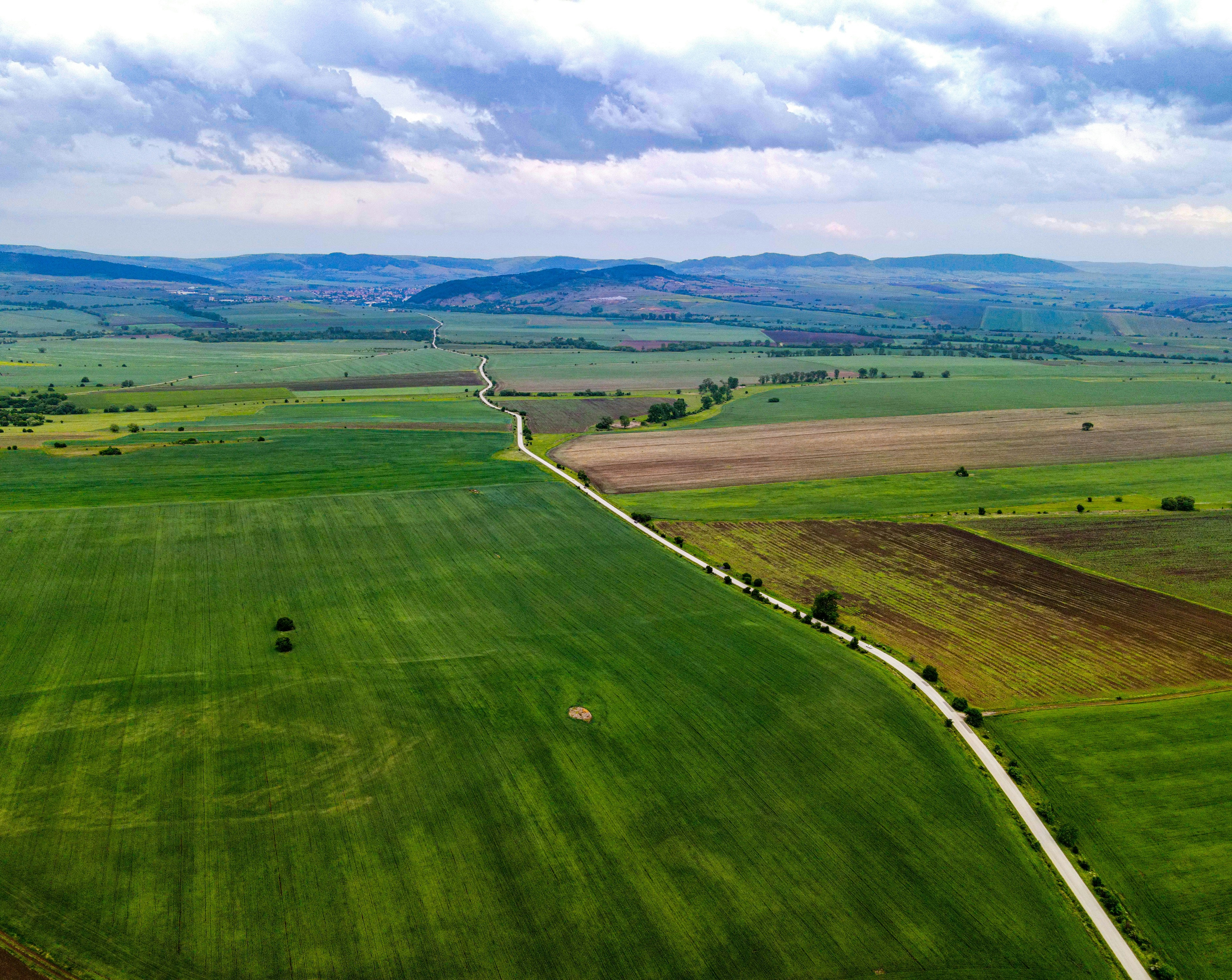 an aerial view of a large green field