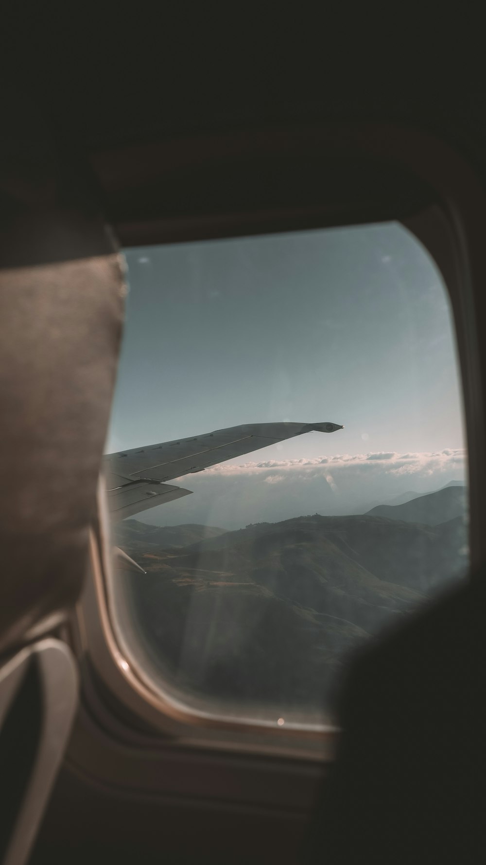 a view out of an airplane window of a mountain range