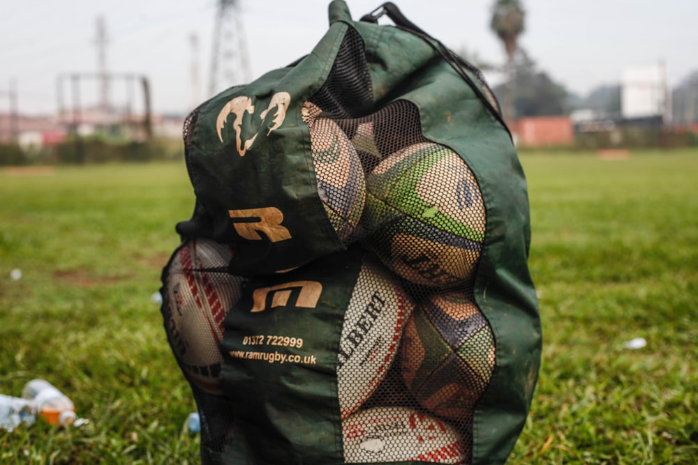 a bag of trash sitting on top of a lush green field