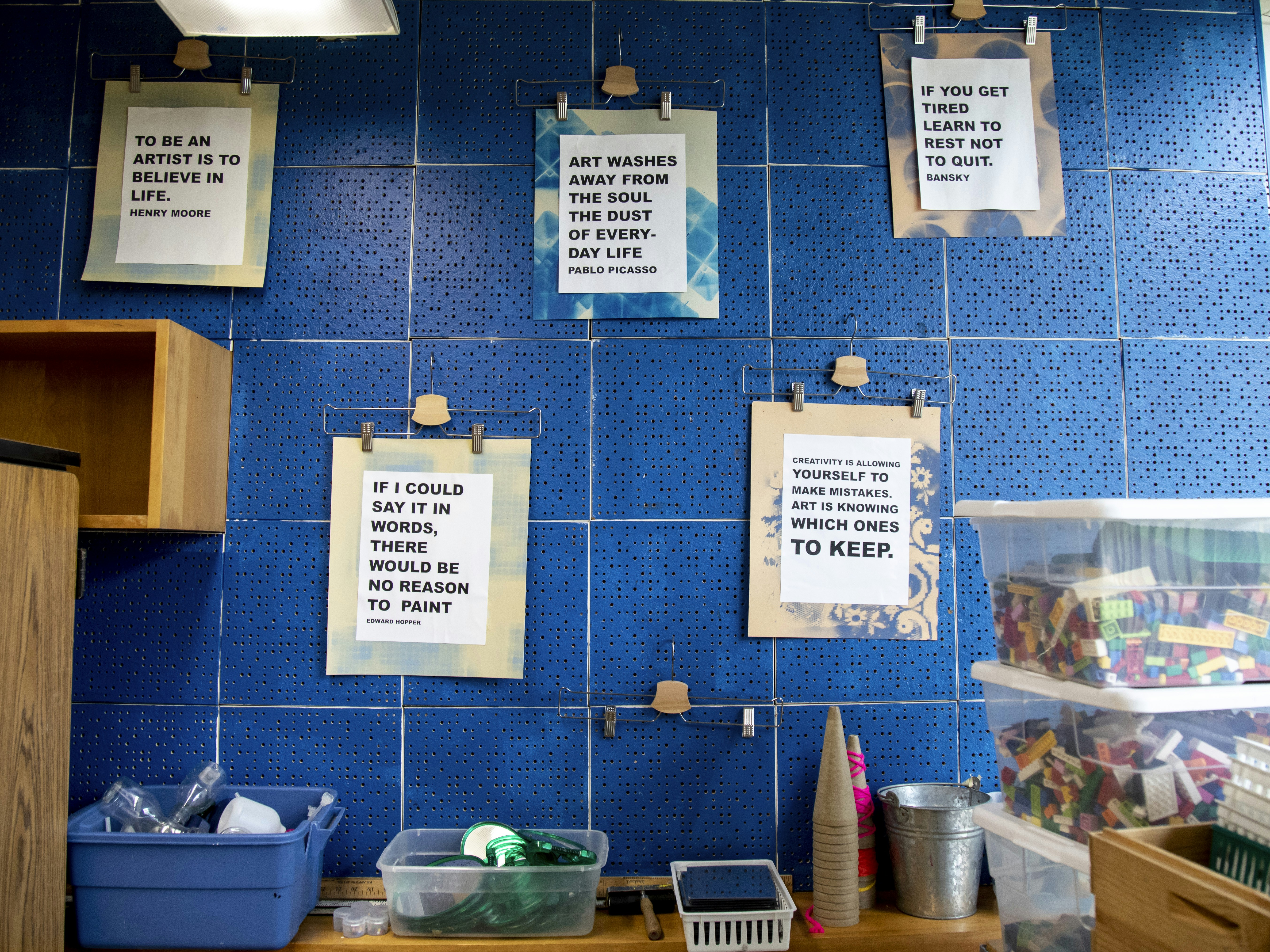 a blue tiled wall with a bunch of signs on it