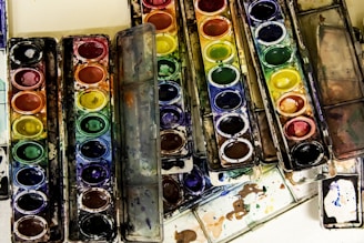 a group of paint cans with different colors of paint in them
