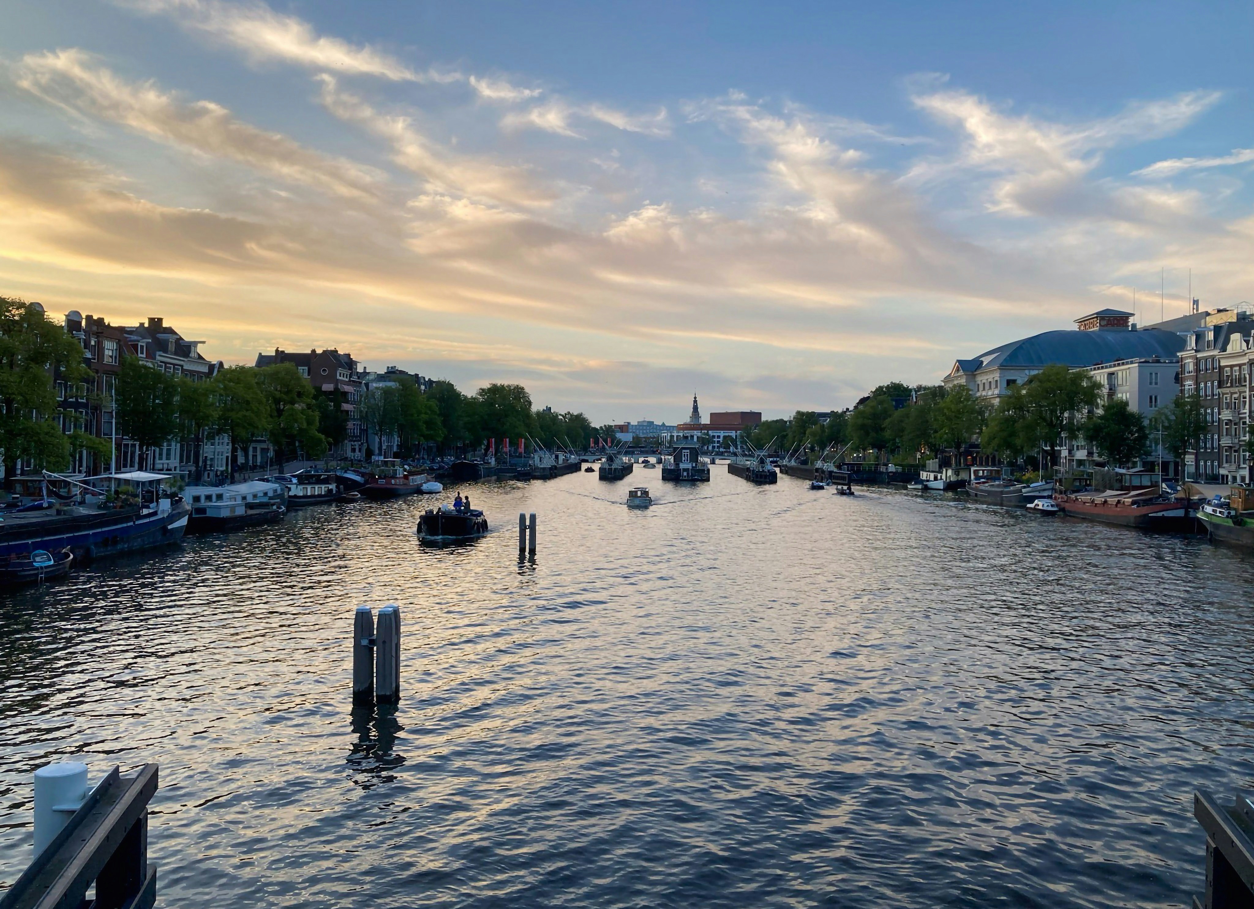 a river with boats on it and a sky background