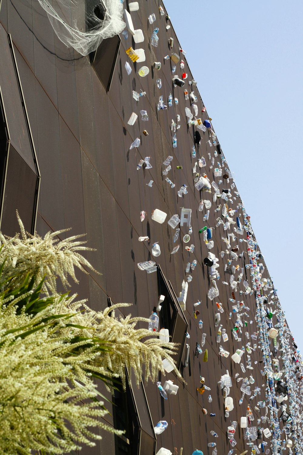 a tall building with a bunch of glass bottles on the side of it