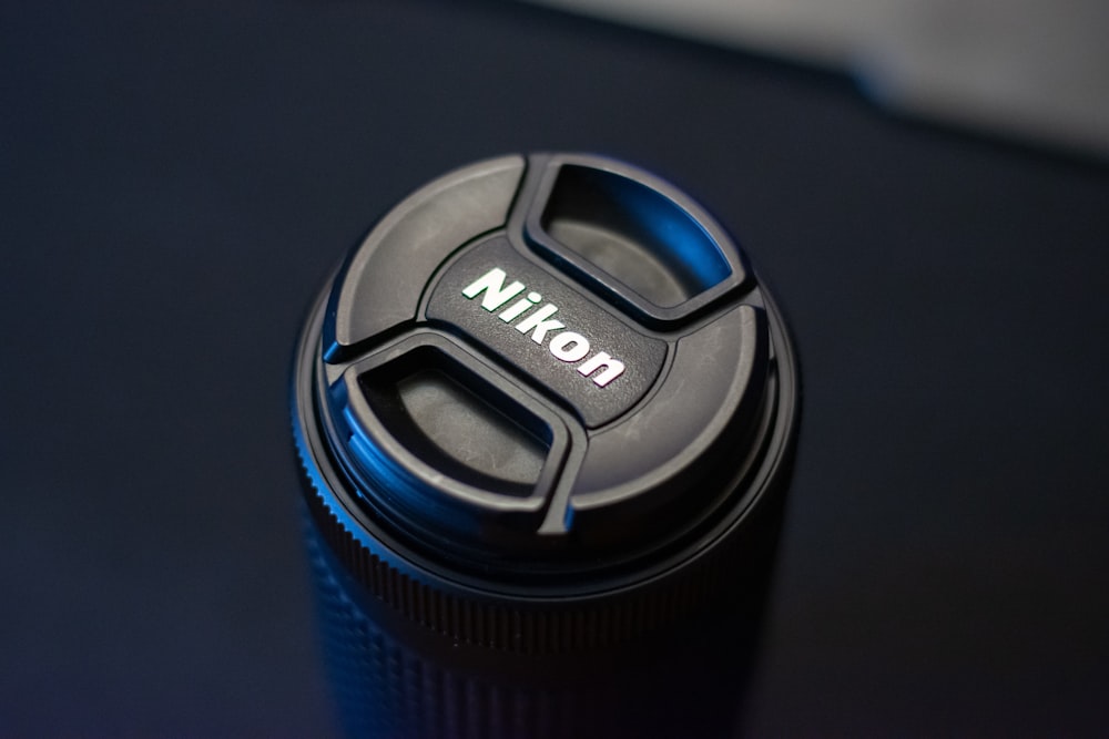 a nikon camera lens cap on a table