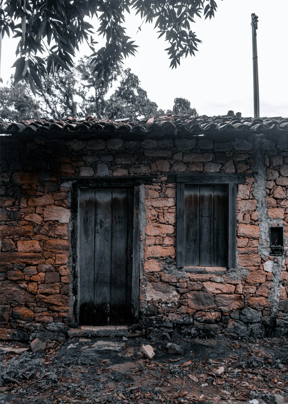 a stone building with two windows and a door