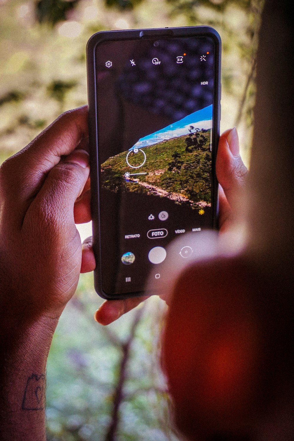 a person holding a cell phone in their hand