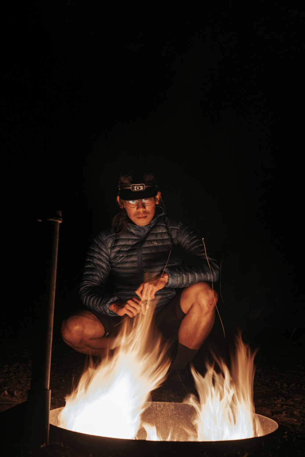 a man sitting on top of a fire pit