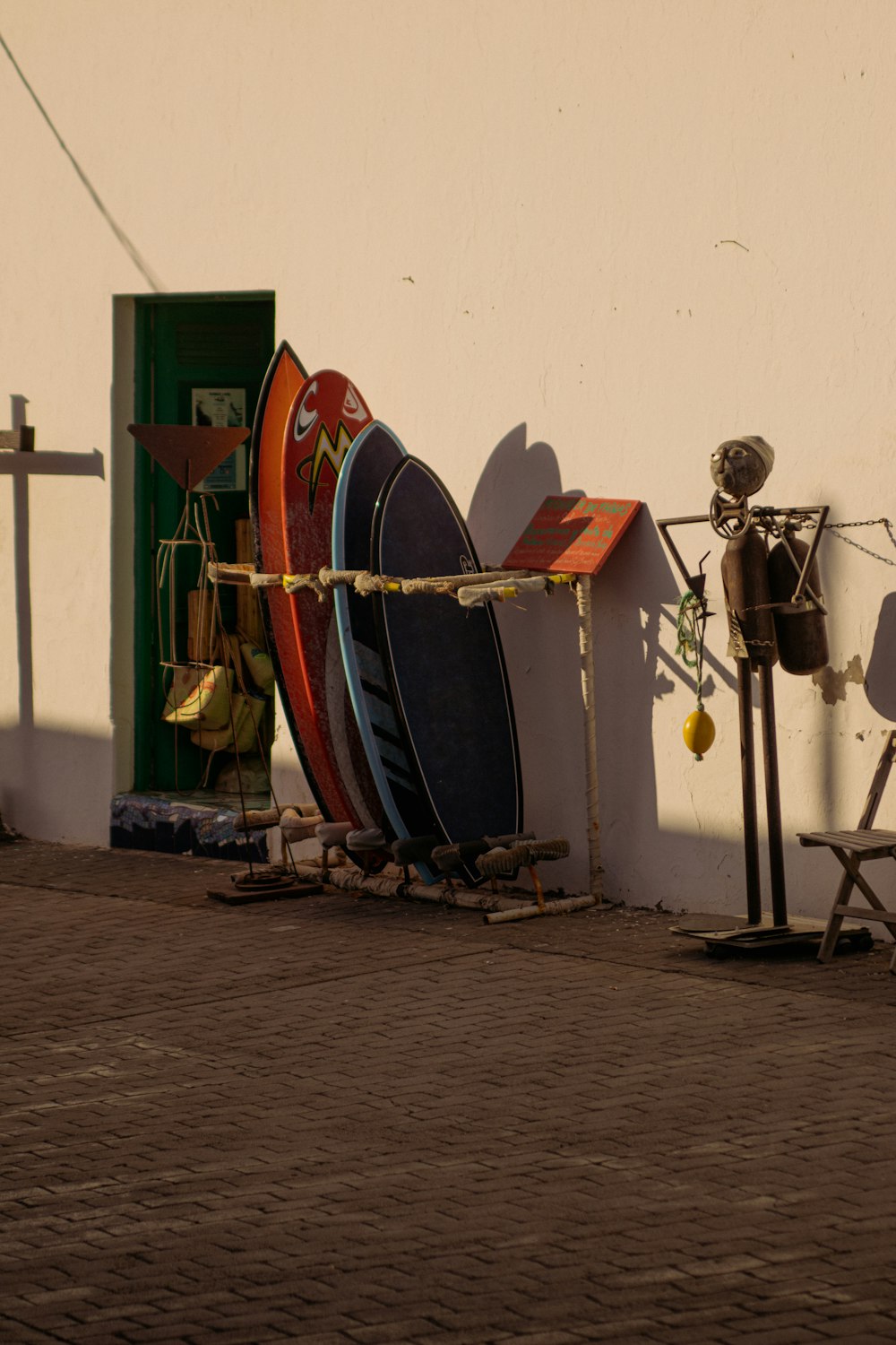 a row of surfboards leaning against a wall