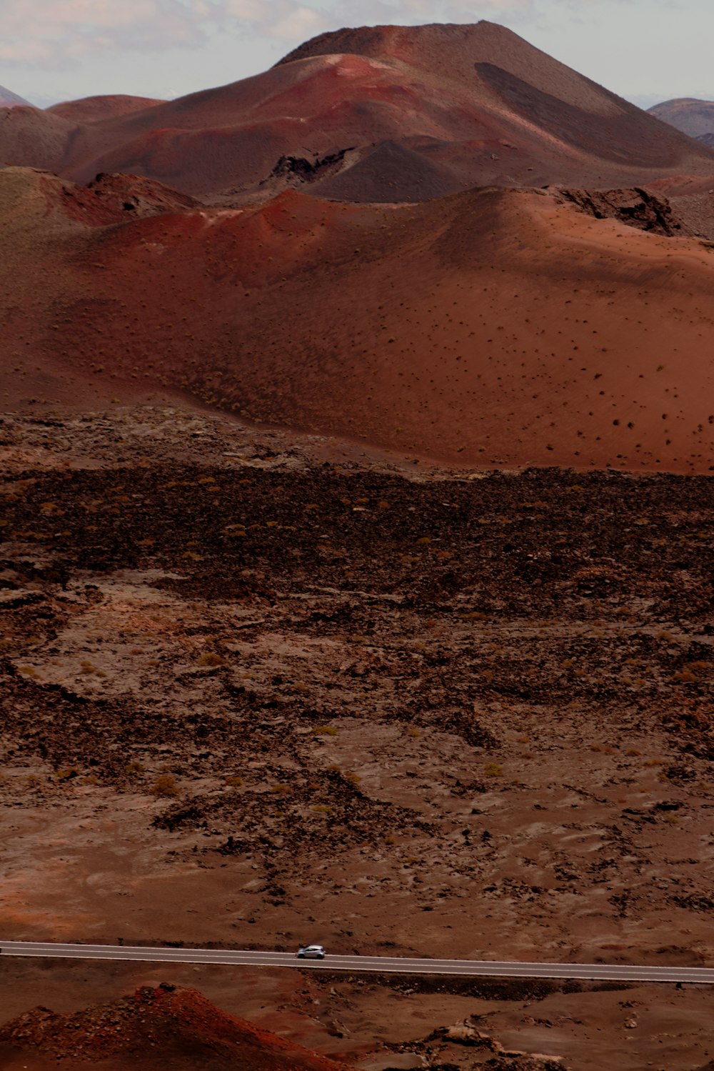 a train traveling through a desert with mountains in the background