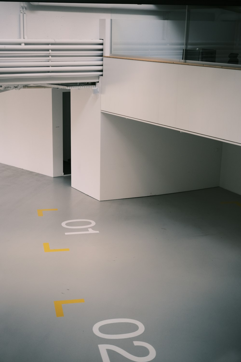 a parking garage with yellow and white markings on the floor