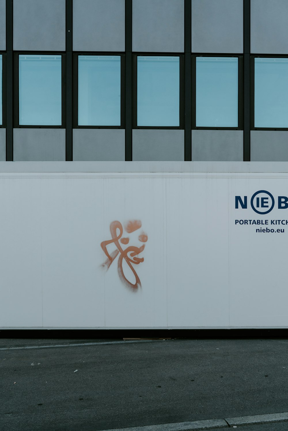 a large white wall with a chinese symbol painted on it