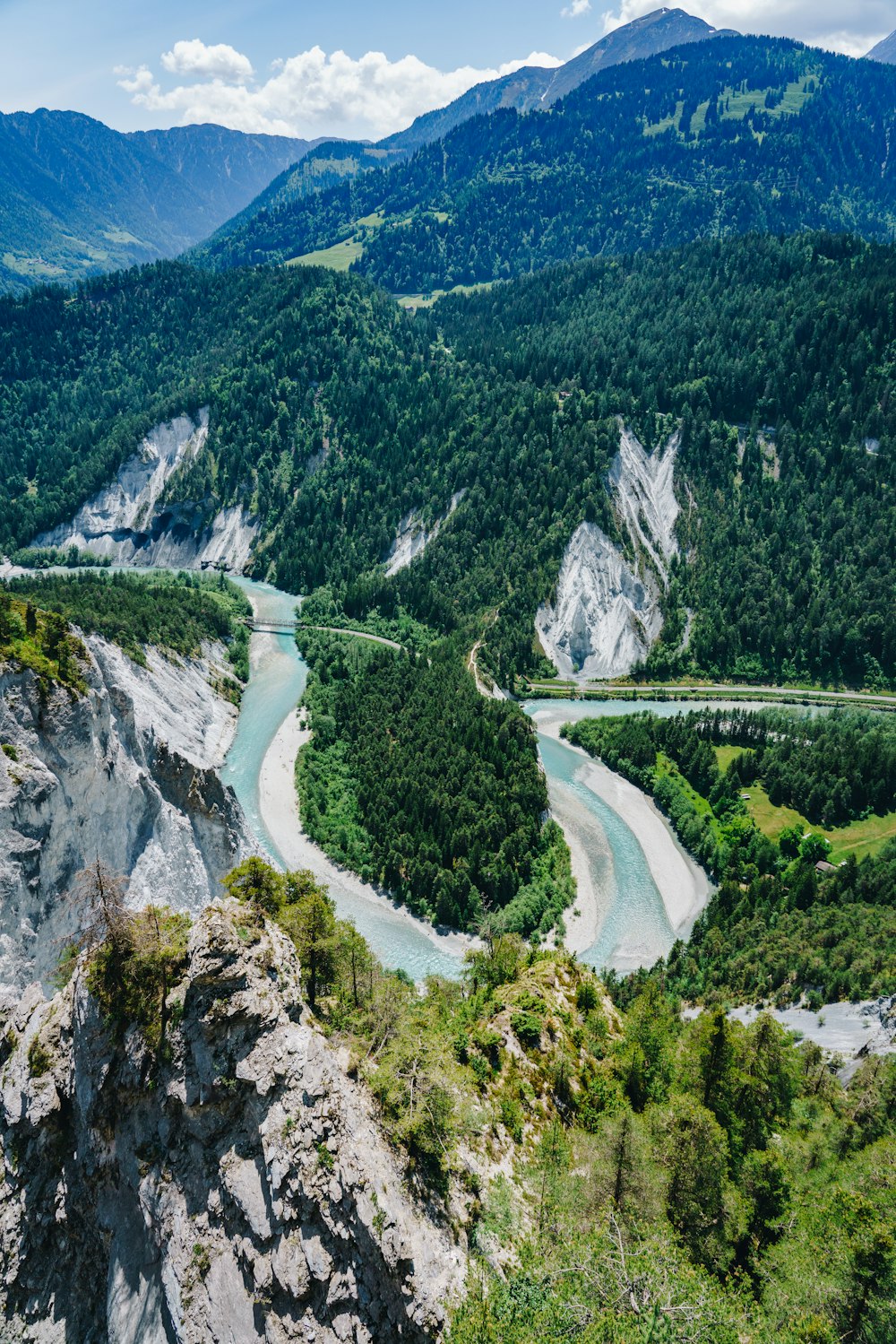 a river flowing through a lush green valley