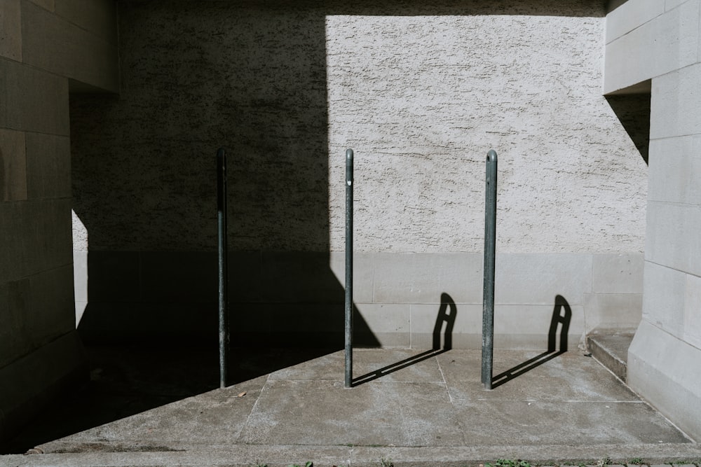 a couple of metal poles sitting next to a building