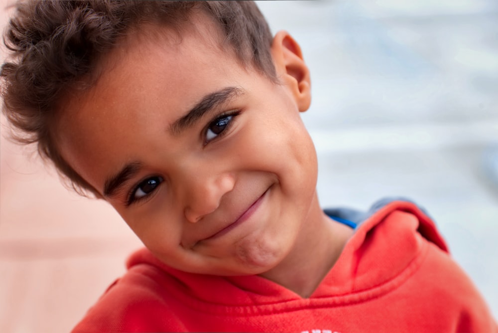 a close up of a child with a smile on his face