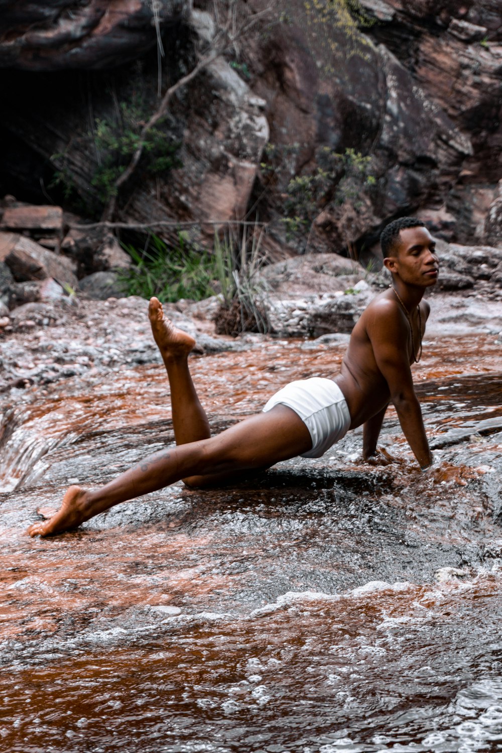 a man laying on his back in a river