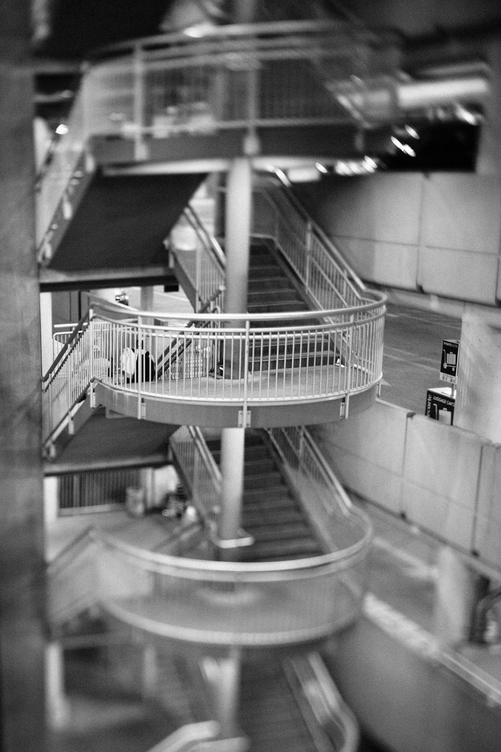 a black and white photo of a spiral staircase