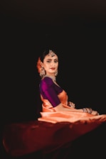 a woman in a purple and orange sari